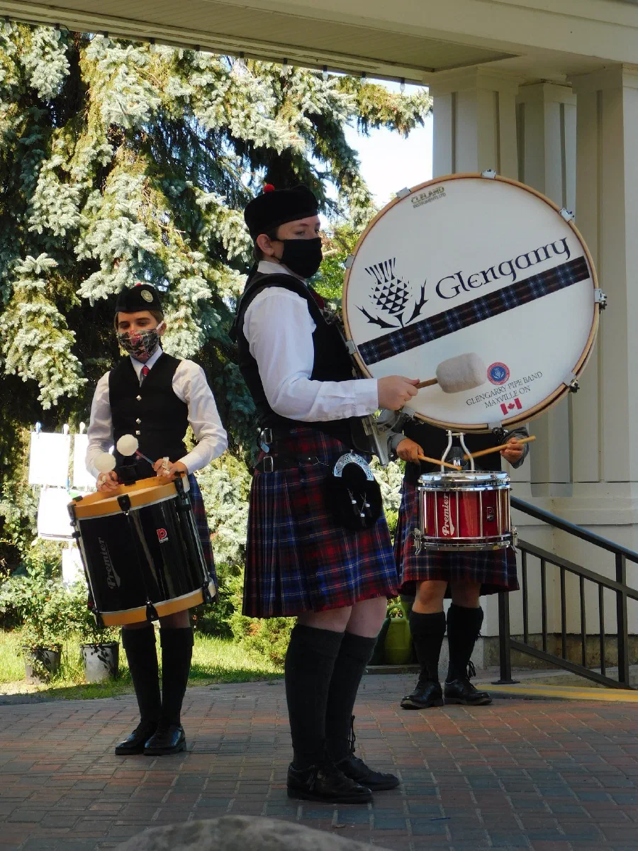 A piper and Highland dancer delivering a PiperGram outdoors